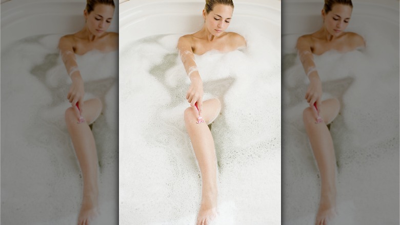 Woman shaving in the tub