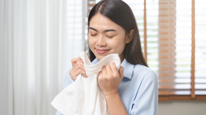 woman holding white T-shirt