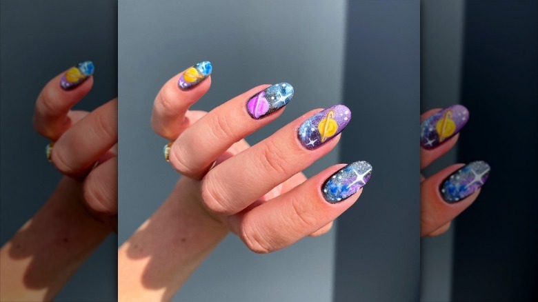 close up of nails with planet designs