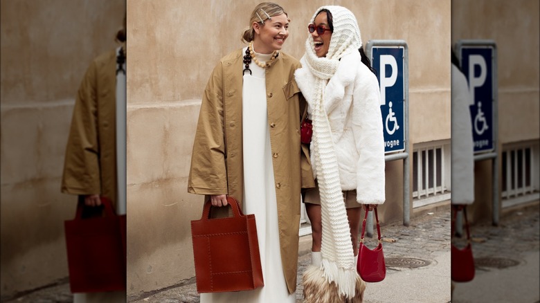 Woman in street holding red tote 