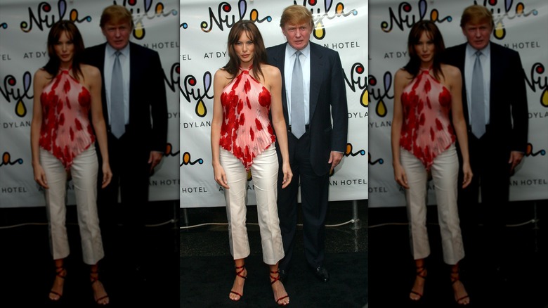 Melania Trump wearing a red and pink halter top, with Donald Trump.