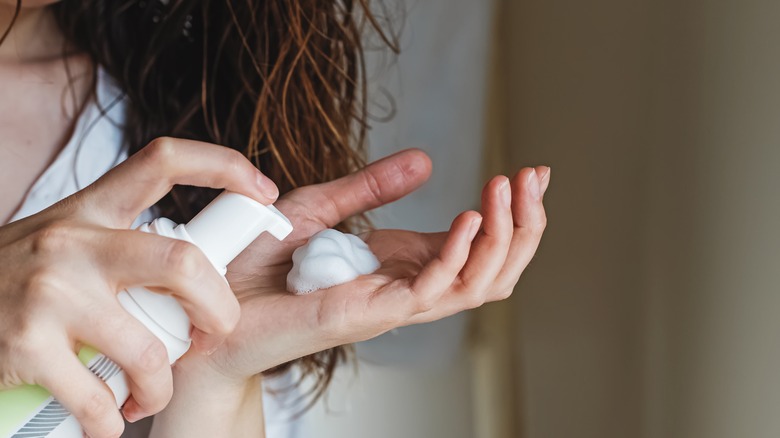 Woman about to apply mousse