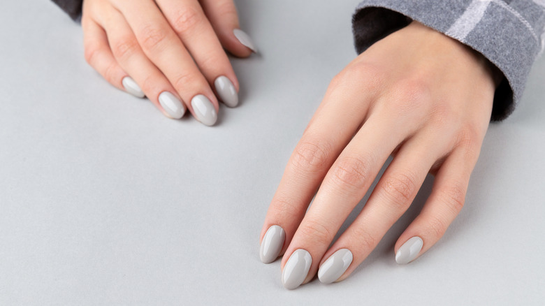 Cloudy gray manicure on hands