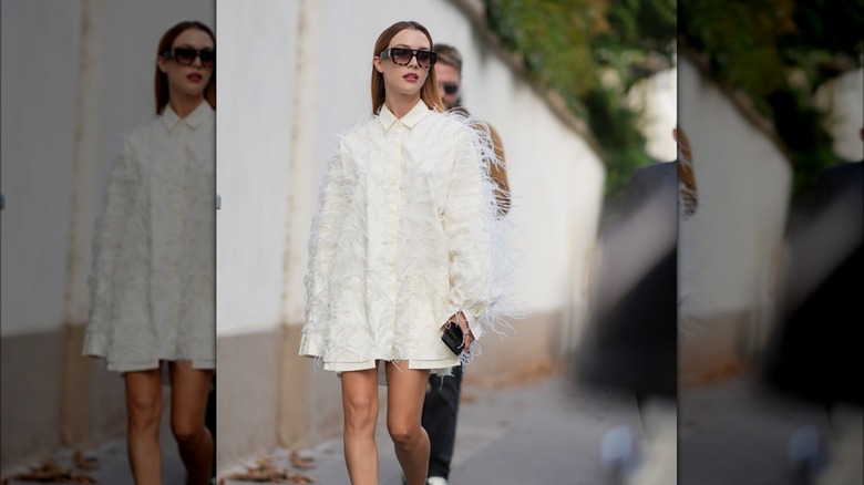 Woman wearing oversized, feathery top