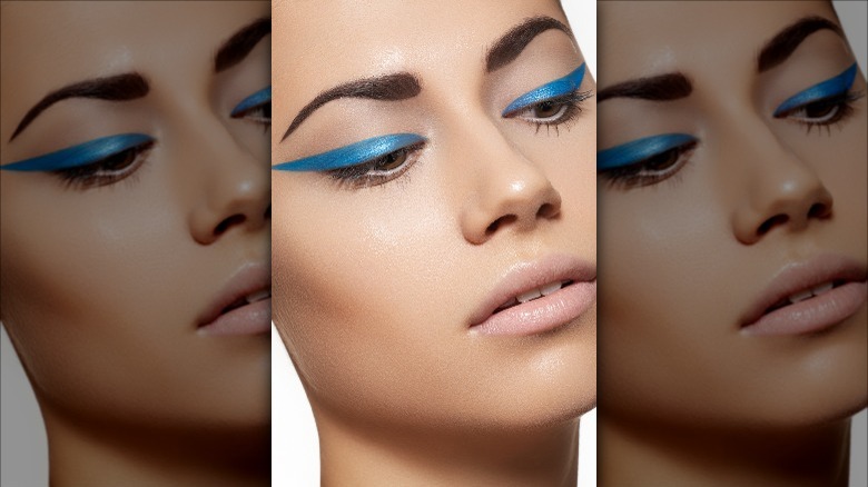 woman with blue exaggerated wing eyeliner