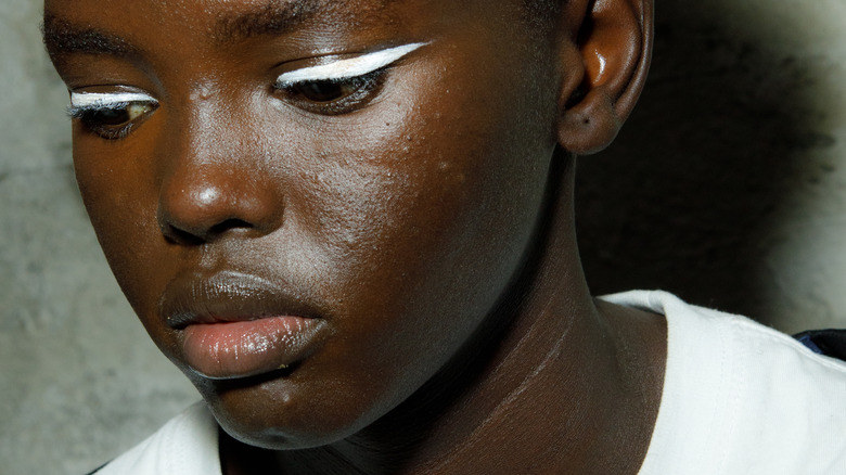 woman with white exaggerated eyeliner