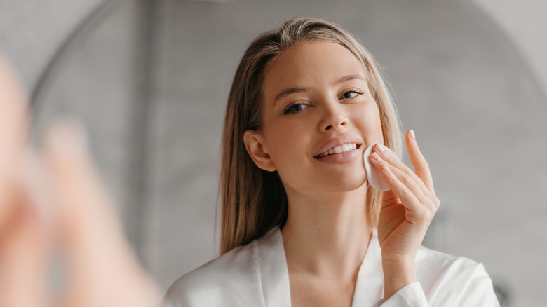 woman applying skincare product