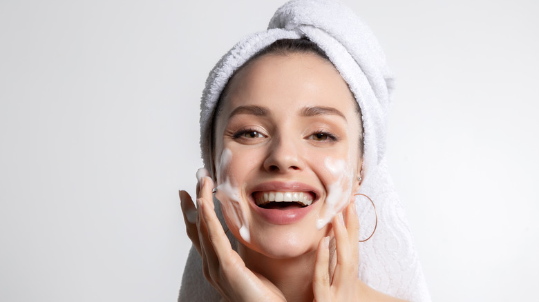 woman applying foaming skincare product