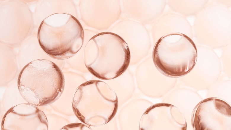 shot of skincare serum droplets