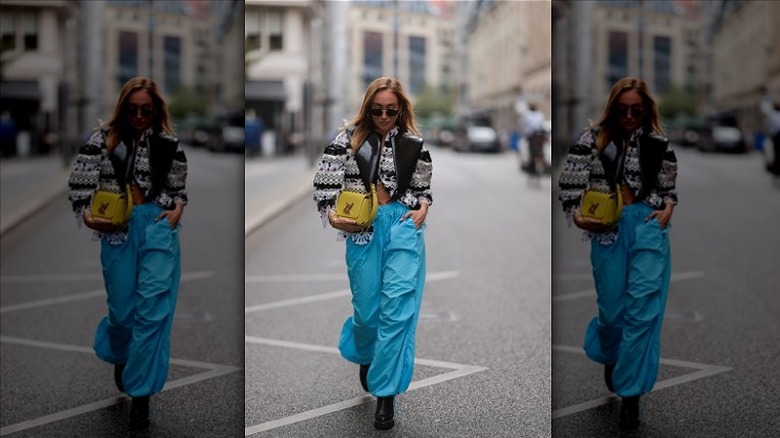 woman wearing blue parachute pants