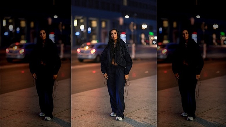 woman wearing navy parachute pants