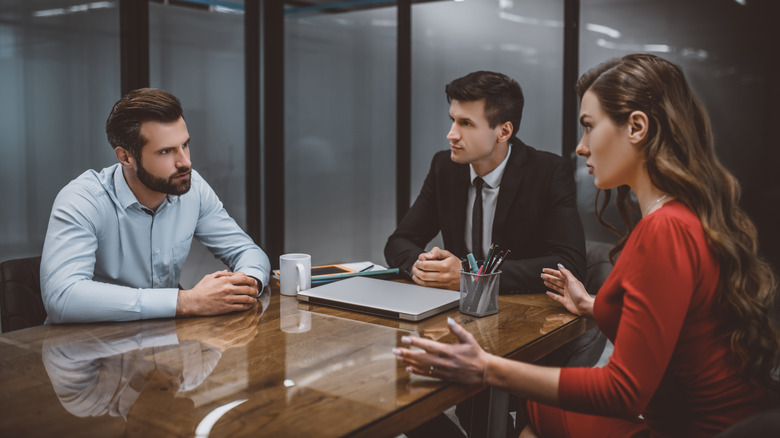 Three people board room