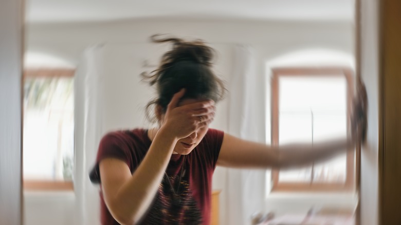 Woman with headache holding her forehead