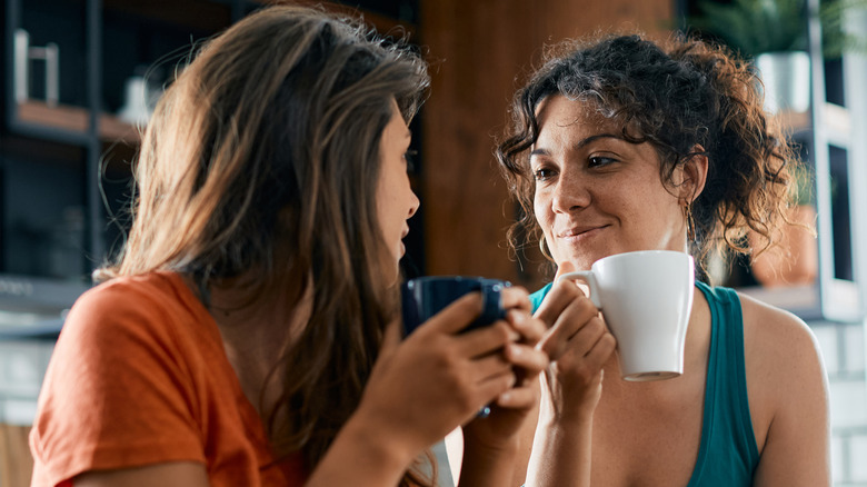 two women talking with coffee