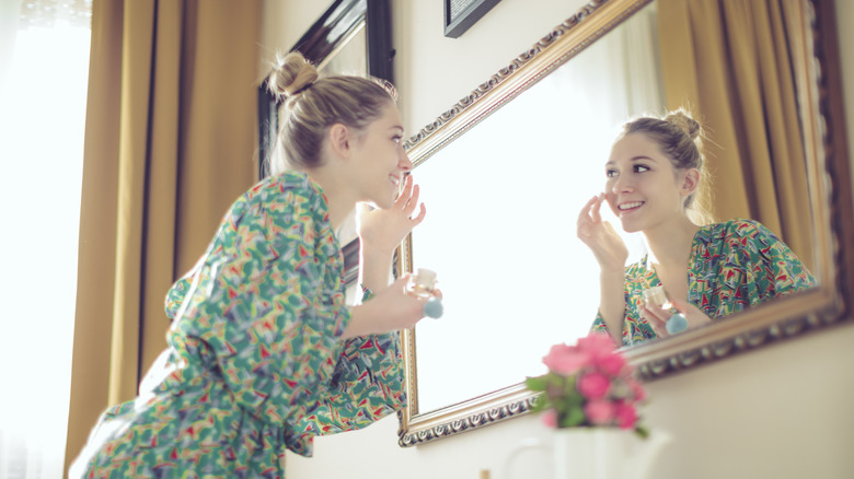 Girl applying foundation with fingers