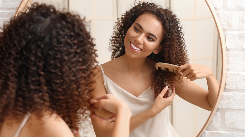 Woman combing hair from the bottom 