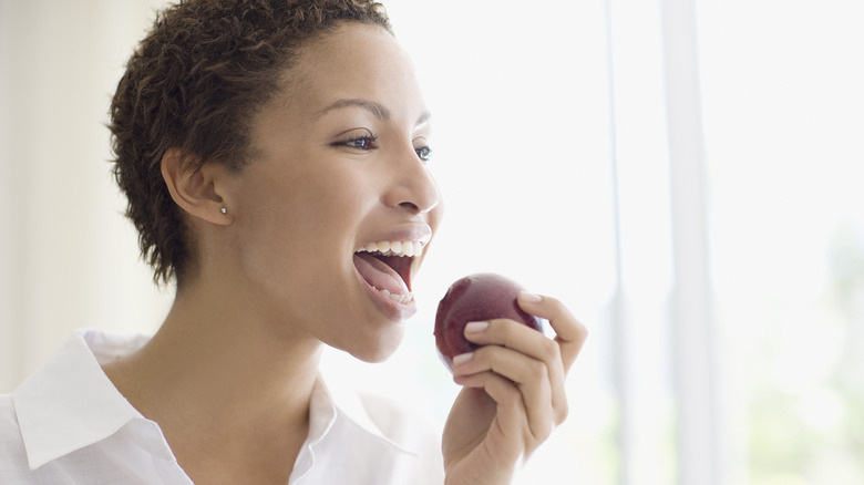 woman biting apple