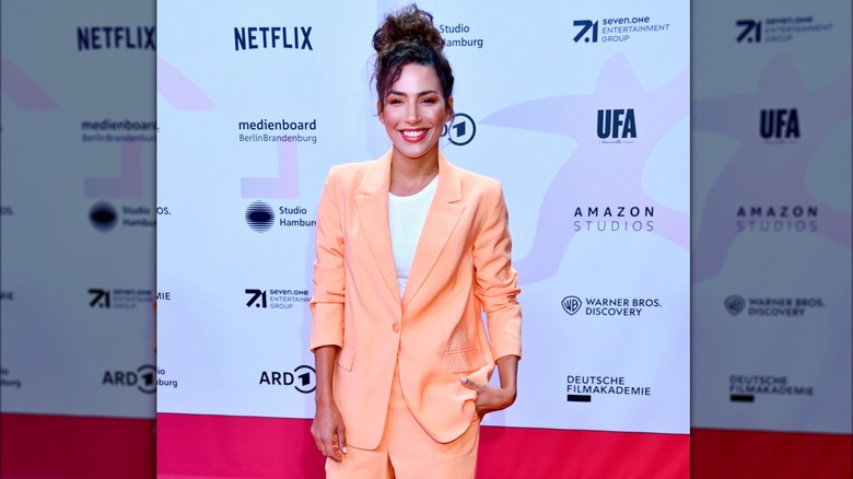 smiling woman wearing peach blazer