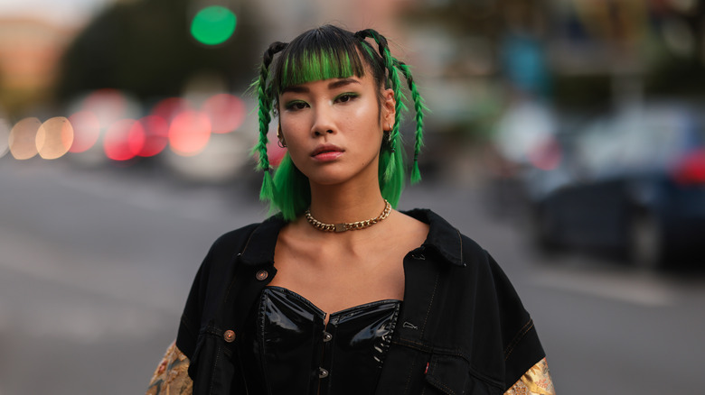 woman with hair in braids and ends in green