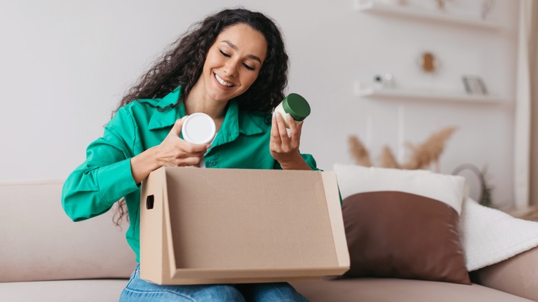 Woman reading skincare package