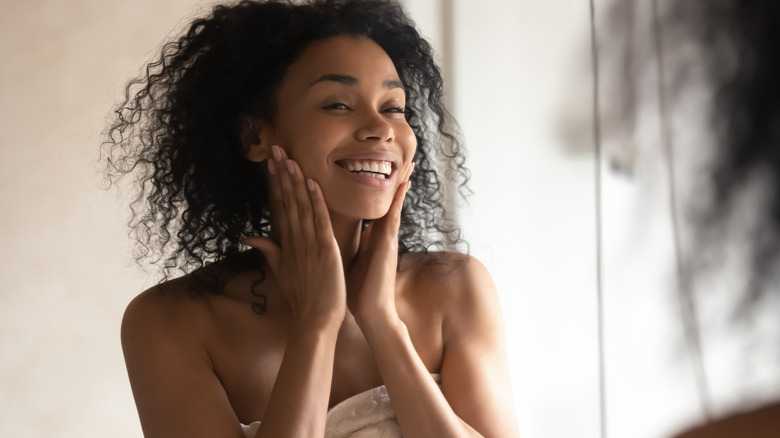 Woman smiling at herself in the mirror