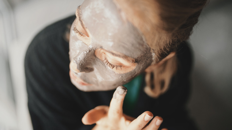 Woman putting on a face mask