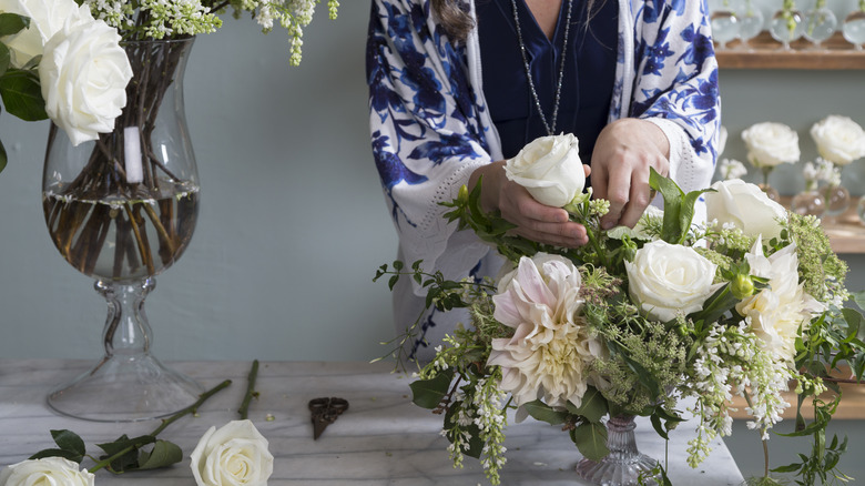 Woman arranges flowers