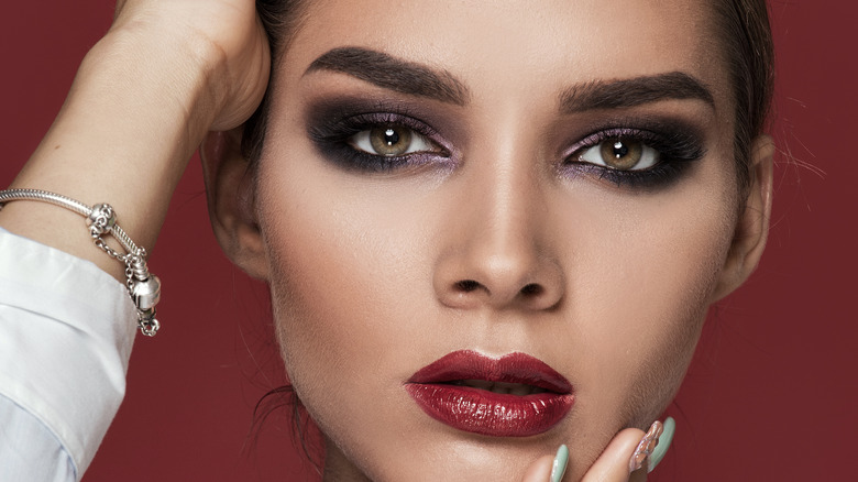 Woman with smoky eyeshadow and red lipstick