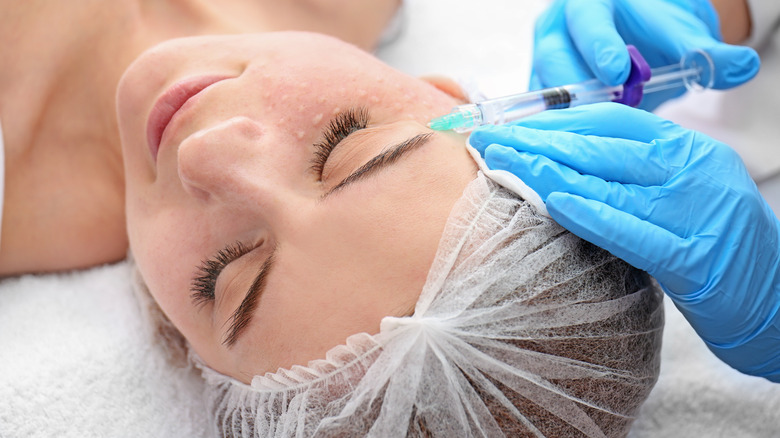 Woman receiving facial injections