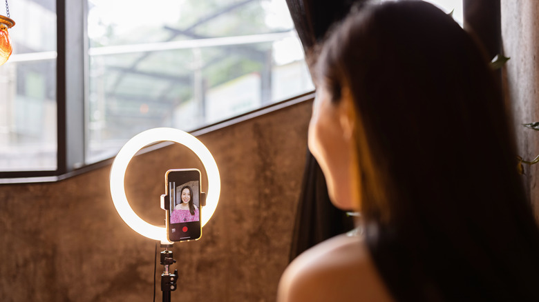 Woman taking picture with ring light 