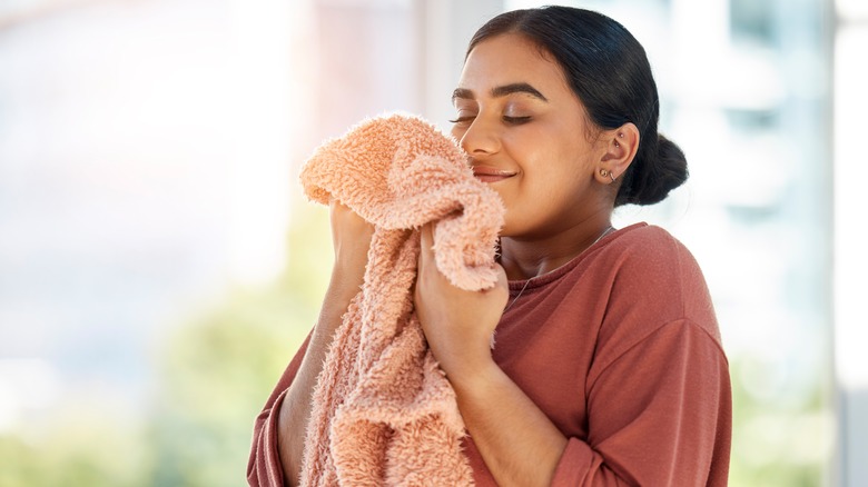 woman smelling clean laundry