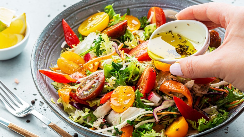 Healthy salad served with lemon, olive oil, and herbs