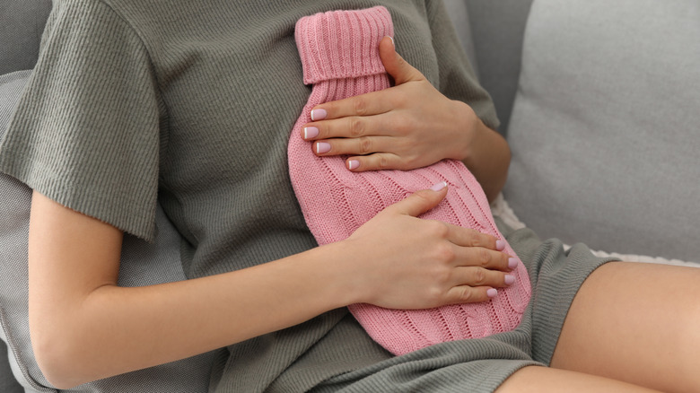 Holding hot water bottle