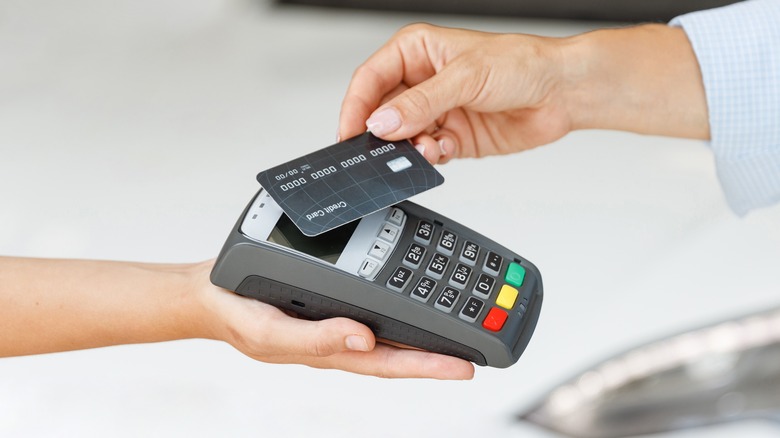 woman paying with credit card