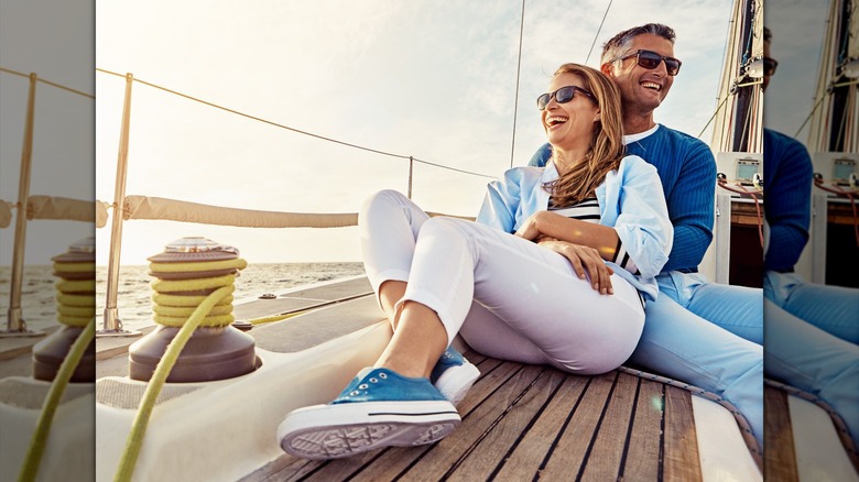 A couple cuddling on a cruise ship, while the woman wears practical flat shoes