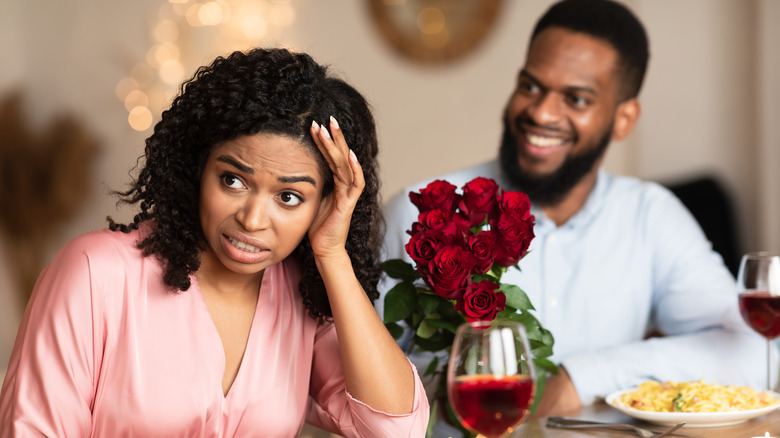 Man with flowers annoys woman