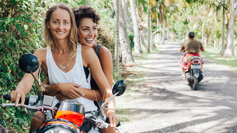 Women riding motorbike together