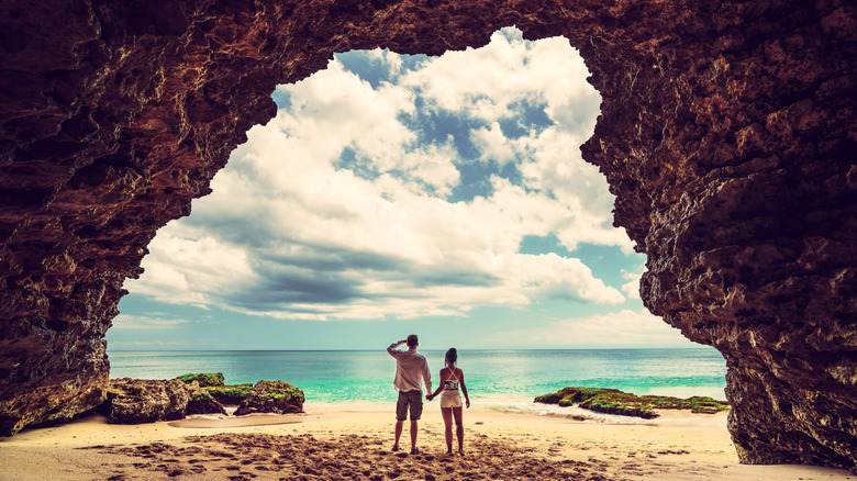 Couple in tropical beach cave