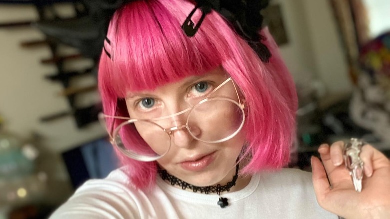 Person with short pink hair