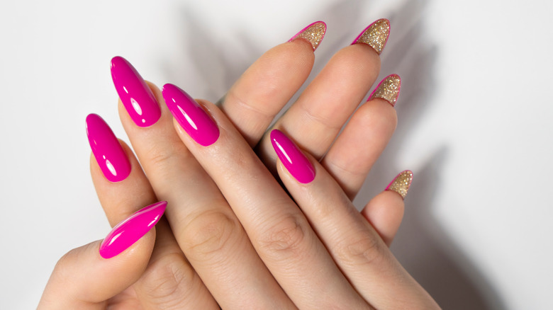 hot pink nails with gold glitter 