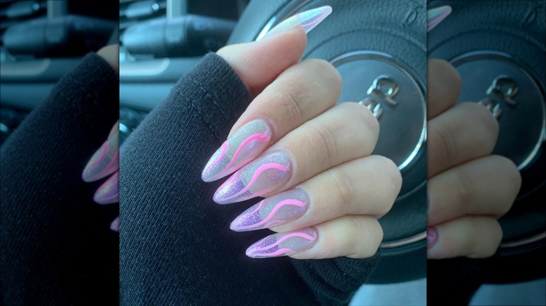 hand with pink swirl nails