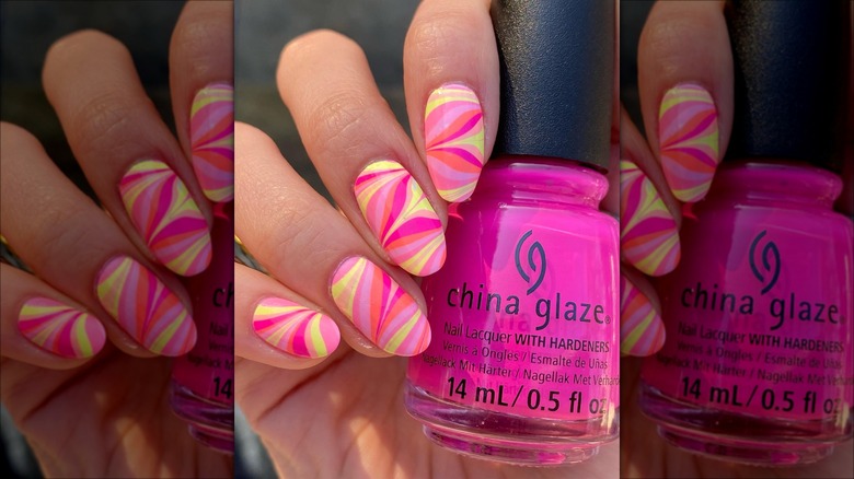 hand with retro pink swirl nails