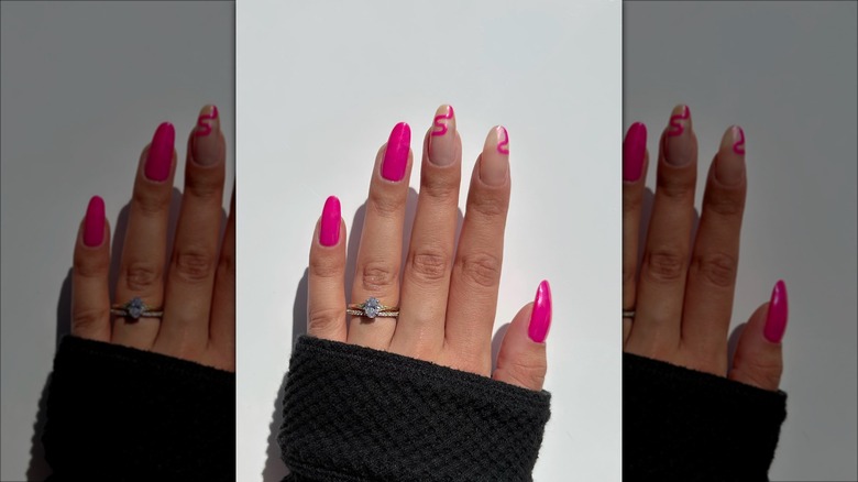 hand with hot pink swirl nails