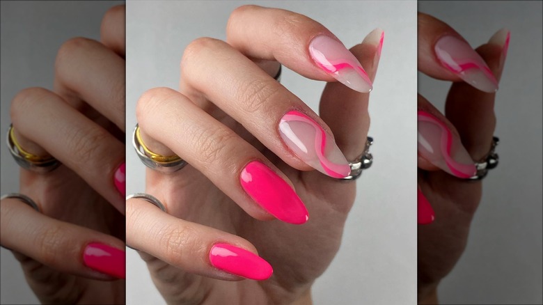 hand with hot pink swirl nails