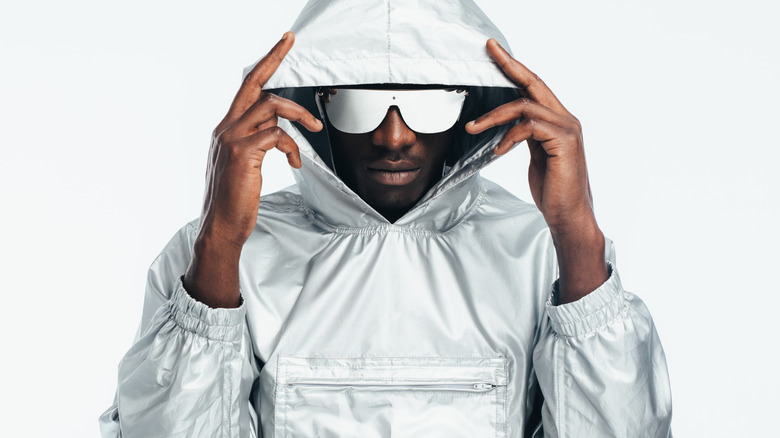 Black man wearing silver hoodie and sunglasses