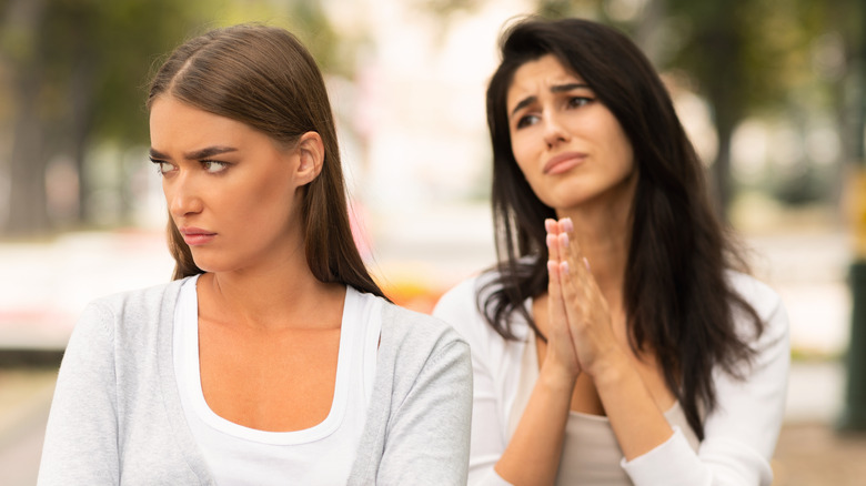 Women fighting with one begging