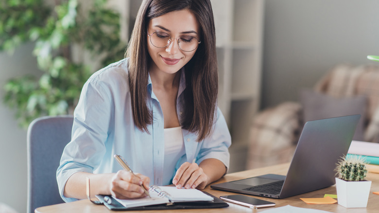 Girl Holding Notepad