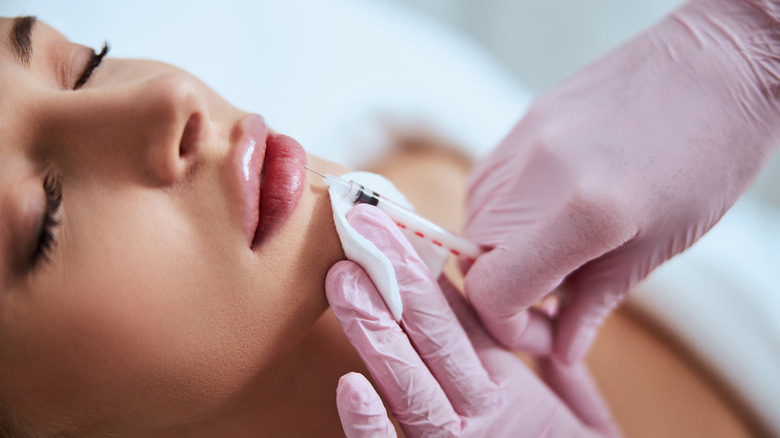 woman undergoing lip enhancement filler