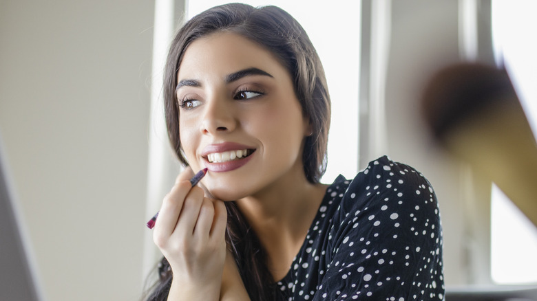 Woman applying lip liner