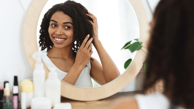 hairdresser using flat iron